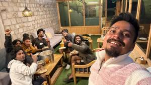 a group of people sitting around a table at Hotel T-Suru Leh in Leh