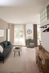 a living room with a couch and a table at AuxMoulins in Neuchâtel +9 photos