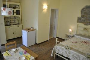 a room with a kitchen and a bed and a table at Apartment Pod Kostanji in Osp +14 photos