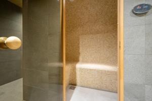 a shower with a glass door in a bathroom at Gîte DDS - Bridge into nature! in Manhay +36 photos
