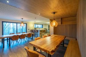 a dining room with a wooden table and chairs at Gîte DDS - Bridge into nature! in Manhay
