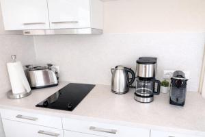 a kitchen counter with a coffeemaker and appliances on it at Floatinghouse Sunday in Ribnitz-Damgarten