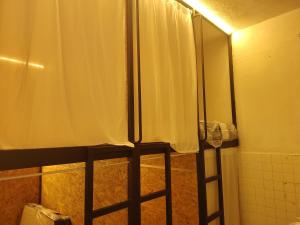 a shower stall with a shower curtain in a bathroom at BM Homestay in Bukit Mertajam