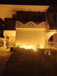 a white building with lights on the side of it at BM Homestay in Bukit Mertajam