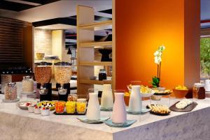 a buffet with different types of food on a table at NH Bogota Pavillon Royal in Bogotá +43 photos