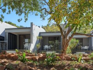 a home with a tree in front of it at ANEW Resort Hunters Rest Rustenburg in Rustenburg