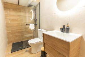 a bathroom with a white sink and a toilet at DouroParadise Apartment in Peso da Régua