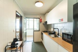 a kitchen with a sink and a counter top at DouroParadise Apartment in Peso da Régua