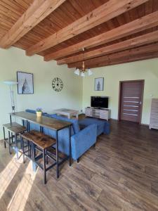 a living room with a blue couch and a table at Penzion Na Hradčanech in Nové Město nad Metují
