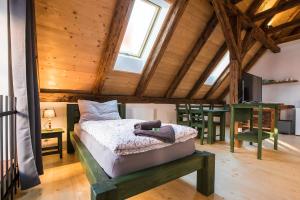 a bedroom with a bed in a room with wooden ceilings at Ubytování V Klenbách in Třeboň