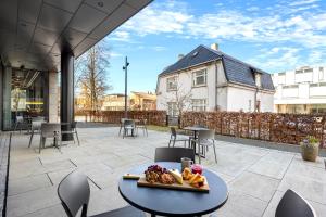 a patio with a table with a plate of food on it at Comfort Hotel Porsgrunn in Porsgrunn