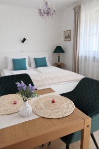 a bedroom with a bed and a table with flowers on it at Ferienwohnungen an der RupertusTherme in Bad Reichenhall +31 photos