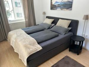 a blue couch with pillows on it in a living room at Mary's Wohlfühlapartment in Landeck