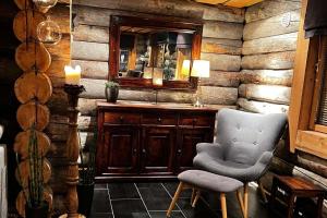 a bathroom with a mirror and a chair in it at Exclusive Cabin with lovly Northern Lights Views in Kilpisjärvi