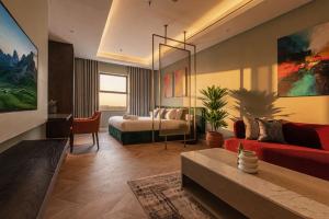 a living room with a bed and a couch at Stella Stays Olaya Tower 1 - Furnished Apartments in Riyadh