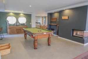 a room with a pool table and a fireplace at 3066 Water Edge in Parys