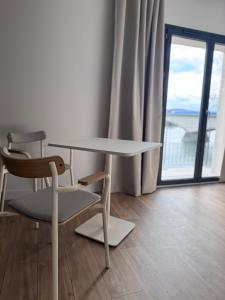 a table and two chairs in a room with a window at Gîtes les rives de Saône in Saint-Didier-sur-Chalaronne +27 photos