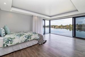 a bedroom with a bed and a view of the water at 3066 Water Edge in Parys +43 photos