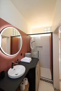 a bathroom with a sink and a mirror at AuxMoulins in Neuchâtel