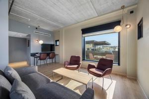 a living room with a couch and chairs at Comfort Hotel Porsgrunn in Porsgrunn