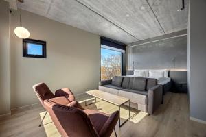 a living room with a couch and a bed at Comfort Hotel Porsgrunn in Porsgrunn