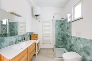 a bathroom with a shower and a sink and a toilet at Villa Giannetta in Canneto