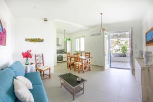 a living room with a blue couch and a table at Villa Giannetta in Canneto