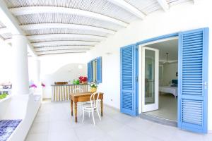 a dining room with blue doors and a table at Villa Giannetta in Canneto +14 photos