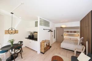 a bedroom with a bed and a table in a room at AuxMoulins in Neuchâtel