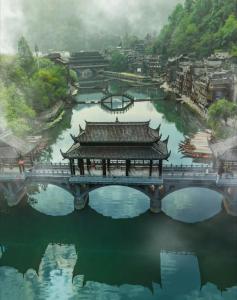 a bridge over a body of water with a city at Phoenix Haven in Fenghuang County +58 photos