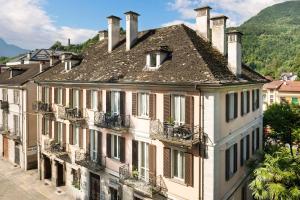 a row of houses with balconies on a street at Bed & Breakfast Tiffany in Domodossola