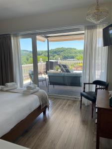 a bedroom with a bed and a living room at Casa Acougo, Sarria in Sarria