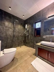 a bathroom with a tub and a toilet and a sink at SAHAS Villa - Private Riverfront Garden Retreat in Beruwala in Beruwala +33 photos