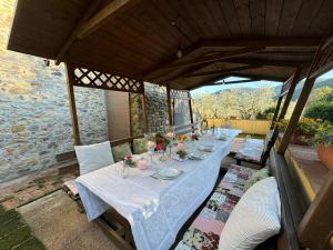 a table with plates of food on a patio at Podere di Mero Casolare in Buti
