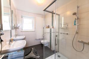 a bathroom with a shower and a sink and a toilet at Haus Heidi mit Balkon in Moosbach +29 photos
