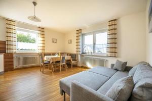 a living room with a couch and a table at Haus Heidi mit Balkon in Moosbach