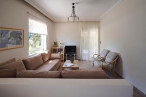 a living room with a couch and two chairs at Avra breeze in Kriopigi