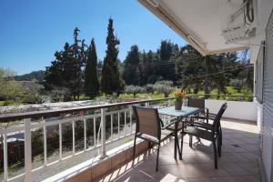a patio with a table and chairs on a balcony at Avra breeze in Kriopigi