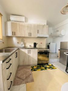 a kitchen with wooden cabinets and a stove at Blue Lemon Hideaway in Poros