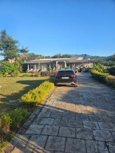 a car parked on a driveway in front of a house at Kaz KAFE in Mamoudzou