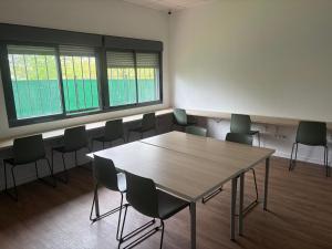 a conference room with a wooden table and chairs at Micampus Logroño Student Residence in Logroño