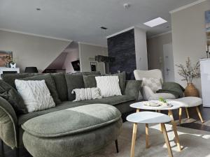 a living room with a couch and a table at Fewo Baltic Dreams in Börgerende-Rethwisch