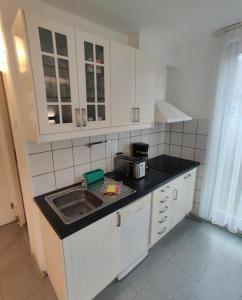 a kitchen with a sink and a counter top at "Tossens Ahoi" in Tossenserdeich +8 photos