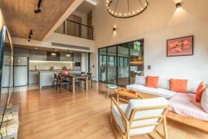 an open living room with a couch and a table at The Vineyard Hideaway Khaoyai in Ban Wang Phaem