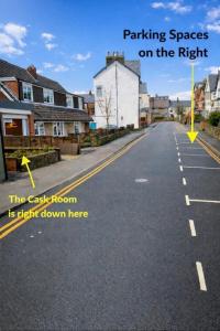 an empty street with a yellow arrow on the road at The Cask Room in Scarborough