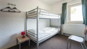a bedroom with two bunk beds and a window at Vakantie oord Zonnehoeve in Valkenburg +42 photos