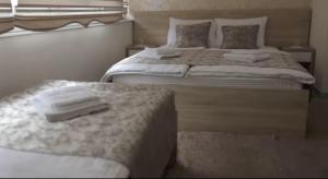two beds in a bedroom with towels on them at Hotel Aldi in Rožaje