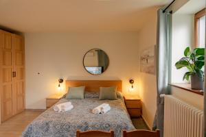 a bedroom with a bed with towels on it at Casa Galya with private patio by GardaDoma in Brenzone sul Garda