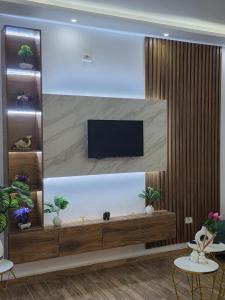 a living room with a flat screen tv on a wall at Maya House - Villa Cap Zbib in Banī ‘Aţāʼ