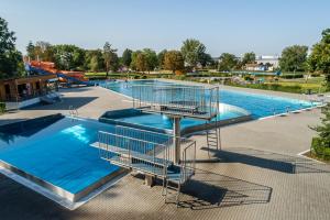 a large swimming pool with blue water at Hotel Panon in Hodonín